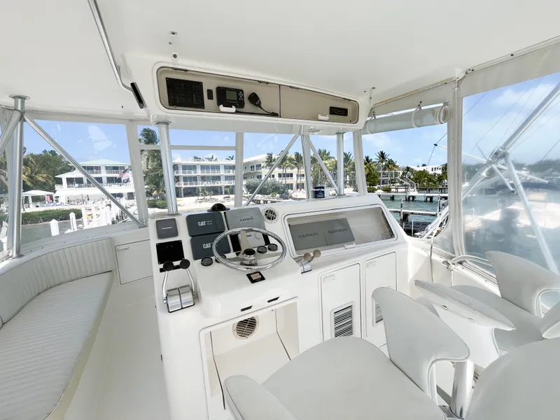 Slide: The Image of 2002 Ocean Yachts 48 Super Sport helm with modern controls and panoramic marina view. - 21