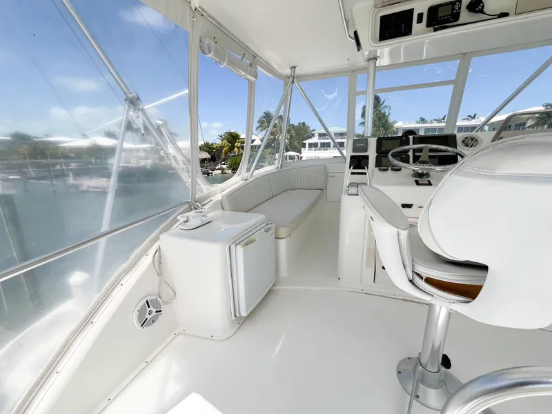 Slide: The Image of 2002 Ocean Yachts 48 Super Sport cockpit with seating, helm, and panoramic windows. - 22