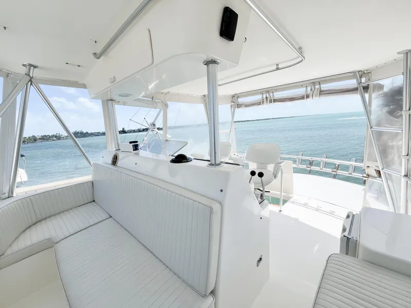 Slide: The Image of 2002 Ocean Yachts 48 Super Sport interior with ocean view, featuring white seating and helm. - 23