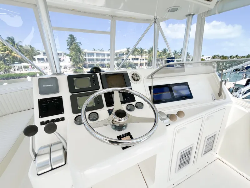 Slide: The Image of Helm of 2002 Ocean Yachts 48 Super Sport with navigation controls and steering wheel. - 24