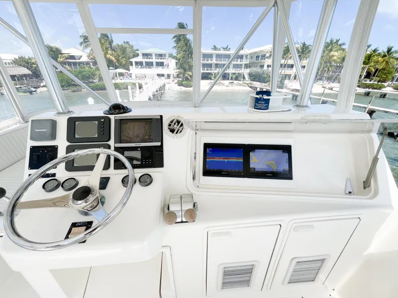 Slide: The Image of Helm of 2002 Ocean Yachts 48 Super Sport with navigation equipment and scenic marina view. - 25