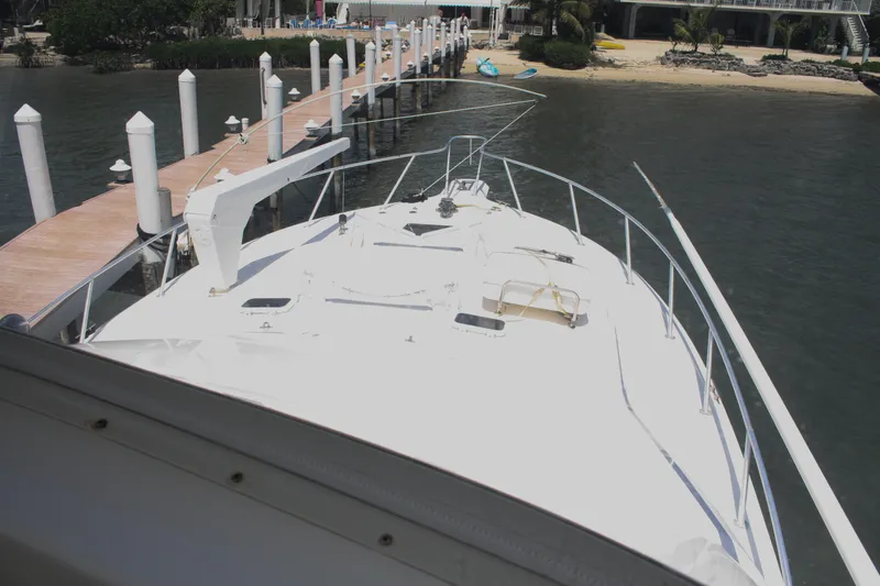 Slide: The Image of 2002 Ocean Yachts 48 Super Sport docked at a marina, view from the bow. - 27