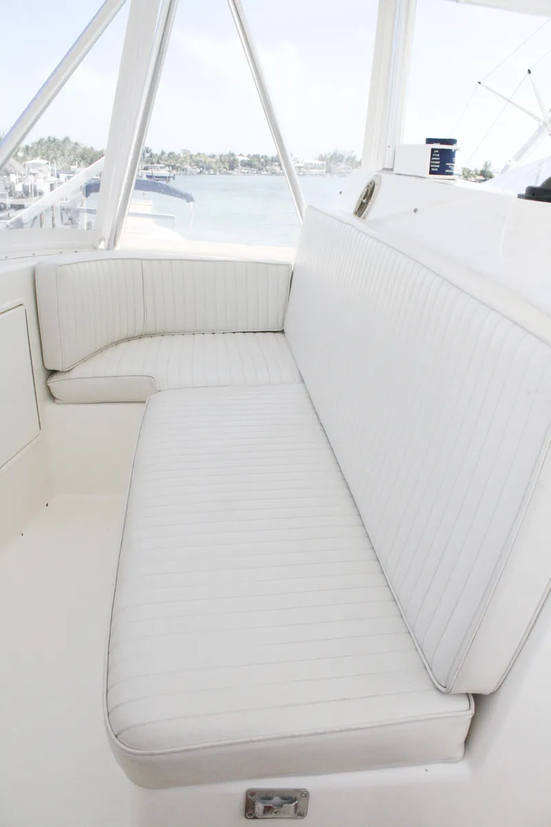 Slide: The Image of 2002 Ocean Yachts 48 Super Sport interior with white seating and panoramic windows. - 28