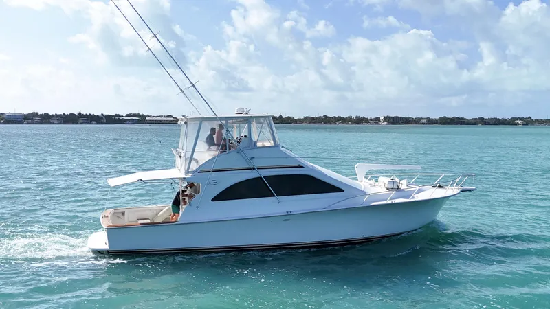 Slide: The Image of 2002 Ocean Yachts 48 Super Sport cruising on clear blue water. - 3