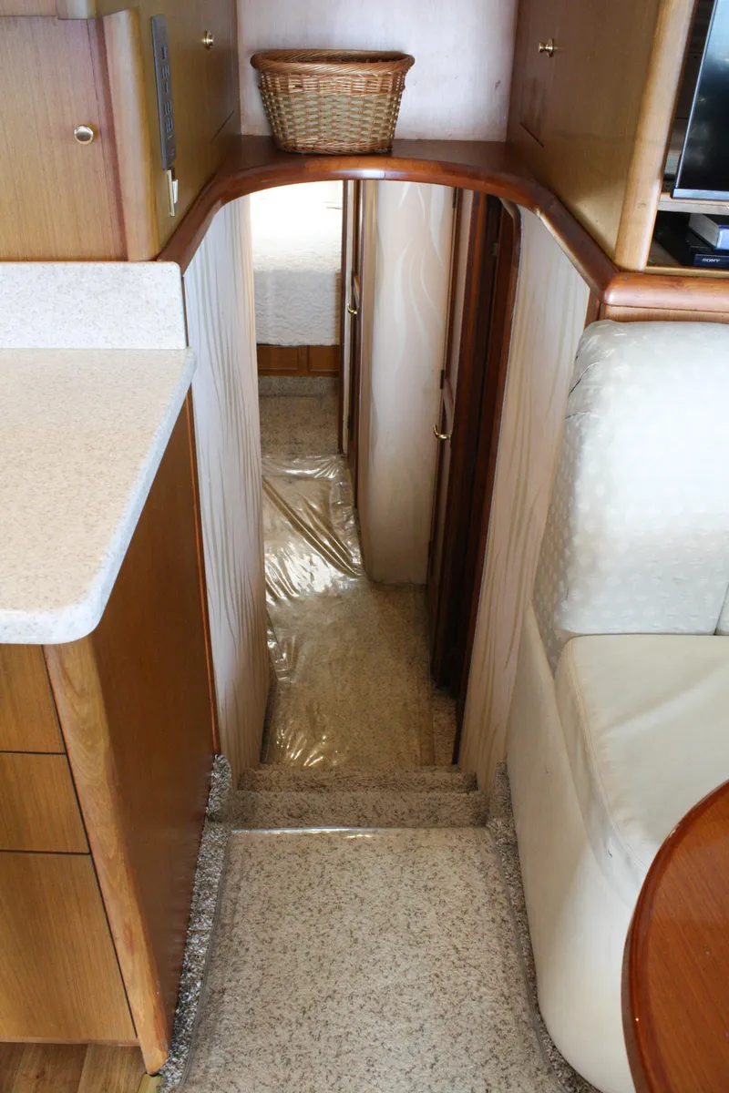 Slide: The Image of Interior view of 2002 Ocean Yachts 48 Super Sport, featuring a narrow hallway and cozy cabin. - 35
