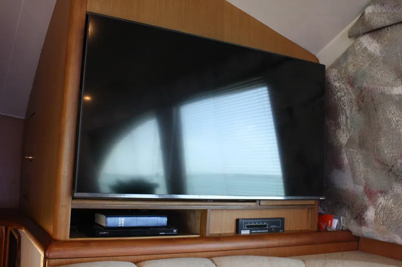 Slide: The Image of Flat-screen TV in 2002 Ocean Yachts 48 Super Sport interior, with wooden cabinetry and electronics. - 36