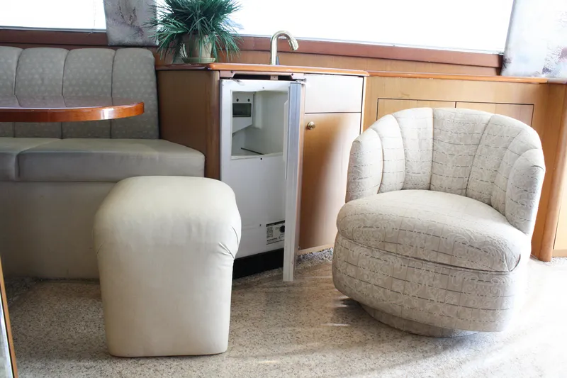 Slide: The Image of Interior of 2002 Ocean Yachts 48 Super Sport with seating, mini fridge, and table. - 37