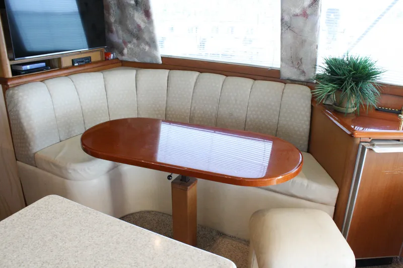 Slide: The Image of Interior of 2002 Ocean Yachts 48 Super Sport with elegant dining area and plush seating. - 38