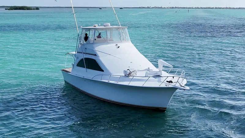 Slide: The Image of 2002 Ocean Yachts 48 Super Sport cruising on turquoise waters. - 5