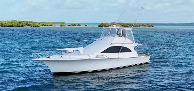 Slide: The Image of 2002 Ocean Yachts 48 Super Sport cruising on clear blue waters. - 7