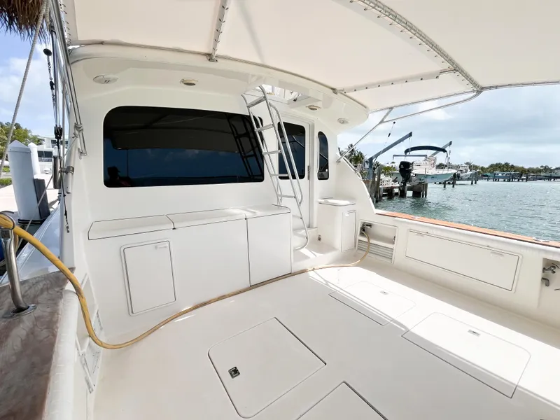 Slide: The Image of 2002 Ocean Yachts 48 Super Sport yacht deck with ladder and marina view. - 9