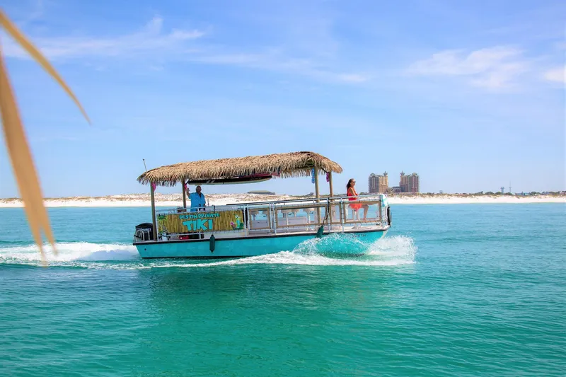 Slide: The Image of Tiki boat cruising on turquoise waters, Beachcat COI Tiki Boat 2022 model. - 10