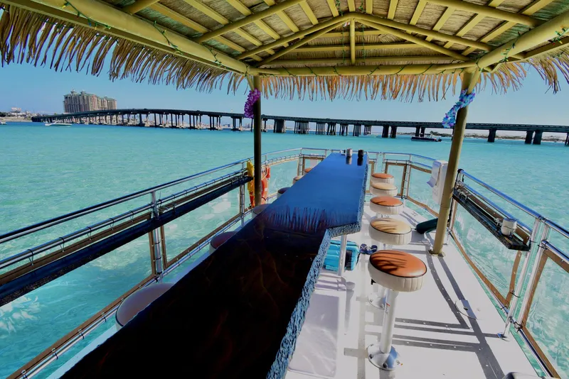 Slide: The Image of Tiki boat with bar seating on turquoise water, 2022 Beachcat COI Tiki Boat. - 14