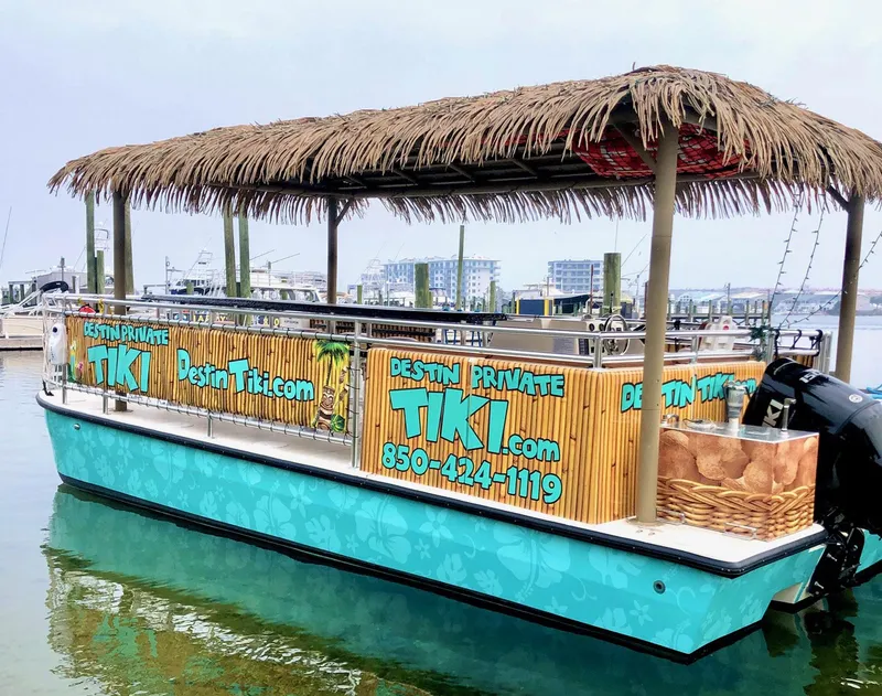 Slide: The Image of 2022 Beachcat COI Tiki Boat with thatched roof, docked in marina. - 3