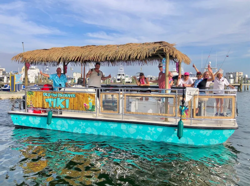 Slide: The Image of 2022 Beachcat COI Tiki Boat with passengers, featuring a thatched roof, on a sunny day. - 6