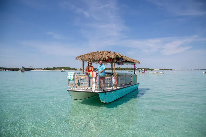 Slide: The Image of 2022 Beachcat COI Tiki Boat on clear water under blue sky. - 9