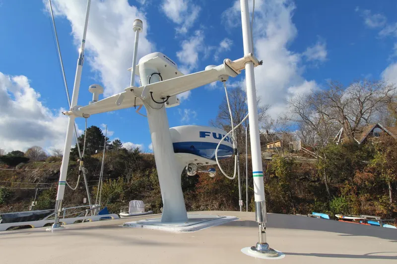 Slide: The Image of Sailboat deck with radar equipment, Holland 32 model, 2020, under a clear blue sky. - 10