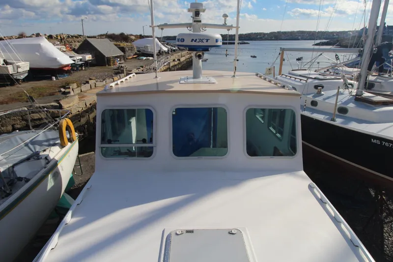 Slide: The Image of Holland 32 boat, 2020 model, docked at a marina with clear skies. - 12