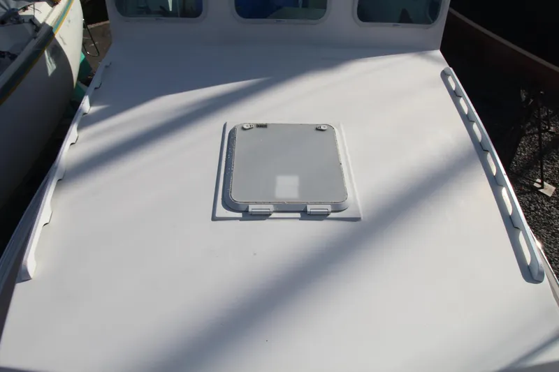 Slide: The Image of 2020 Holland 32 boat deck with hatch, featuring sleek white design. - 13