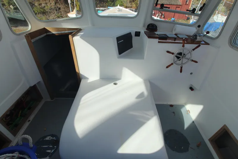 Slide: The Image of Interior of 2020 Holland 32 boat with steering wheel and seating area. - 16