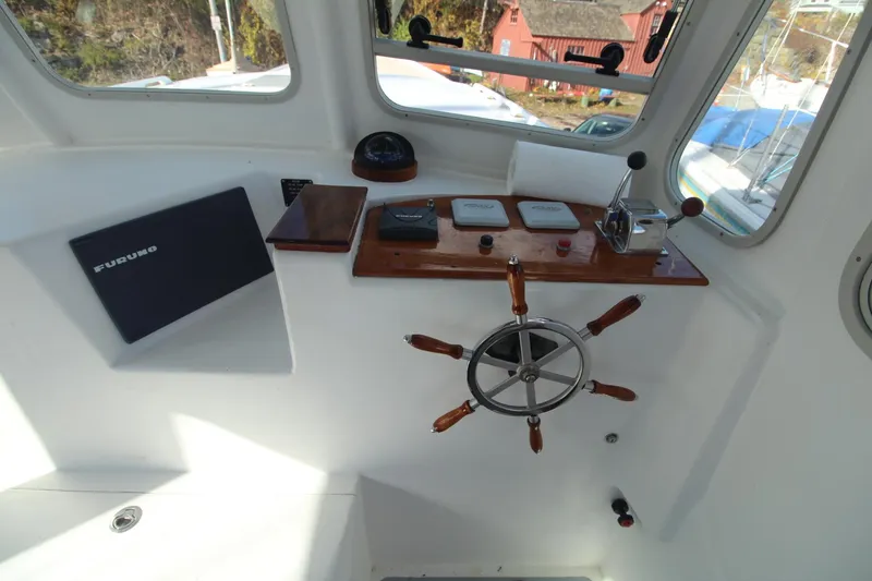 Slide: The Image of Helm of 2020 Holland 32 boat with wooden steering wheel and navigation equipment. - 18
