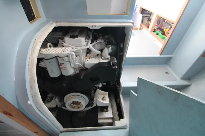 Slide: The Image of Engine compartment of a 2020 Holland 32 boat, showcasing mechanical components and filters. - 26