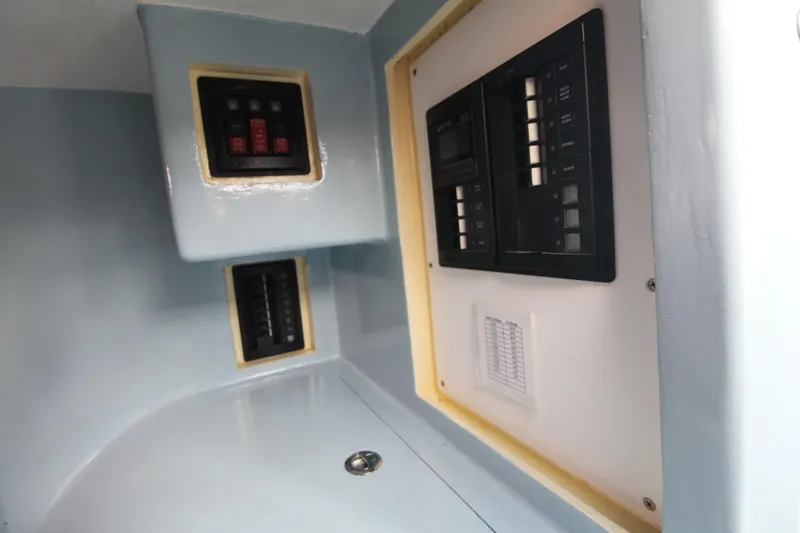 Slide: The Image of Electrical panel inside a 2020 Holland 32 boat, featuring switches and controls. - 27