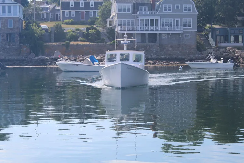 Slide: The Image of Boat cruising near coastal homes, Holland 32 model, 2020. - 29