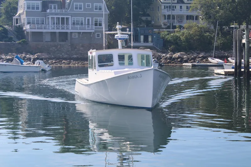 Slide: The Image of 2020 Holland 32 boat "Anna J" cruising in a scenic harbor setting. - 30