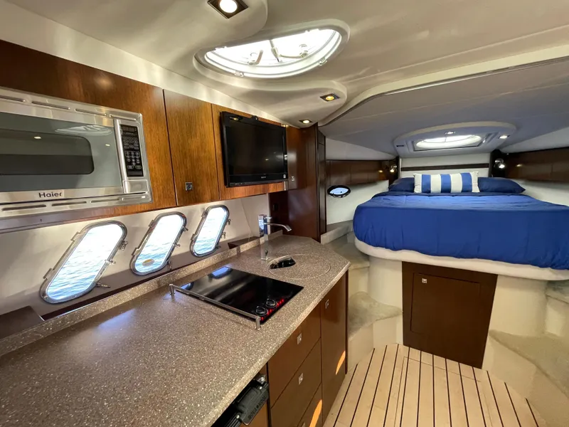 Slide: The Image of Luxurious interior of 2012 Cruisers Yachts 35 Express with modern kitchen and cozy sleeping area. - 17