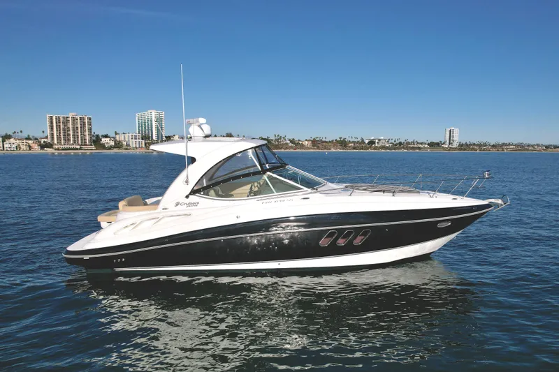 Slide: The Image of 2012 Cruisers Yachts 35 Express on calm water, city skyline in background. - 2