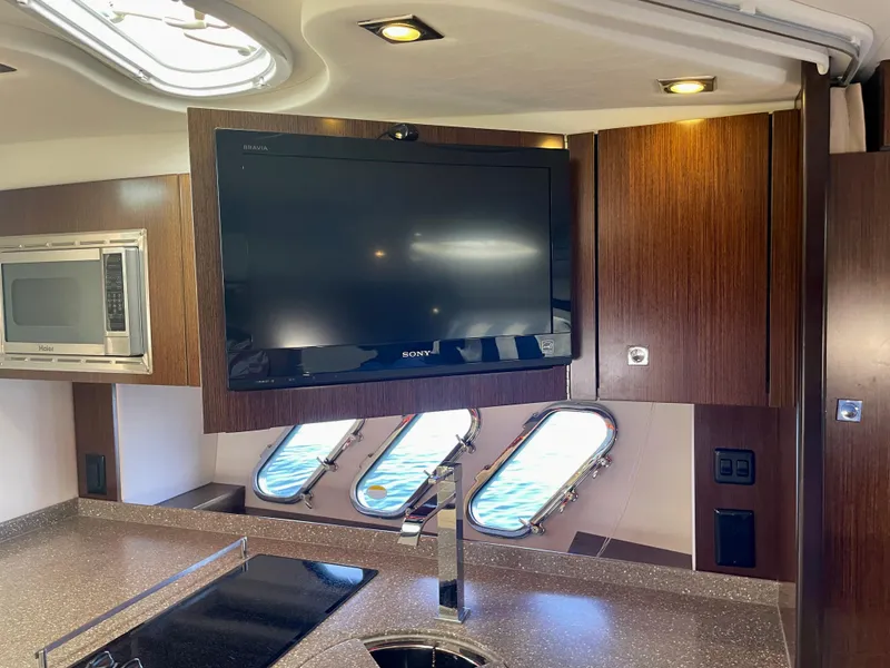 Slide: The Image of Interior of 2012 Cruisers Yachts 35 Express with TV, microwave, and porthole windows. - 20
