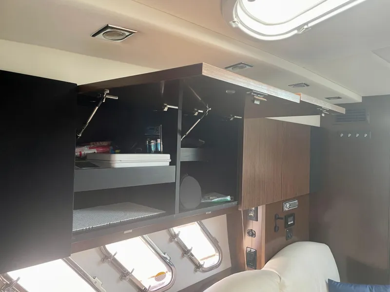 Slide: The Image of Interior of 2012 Cruisers Yachts 35 Express, featuring open cabinets and modern design elements. - 23