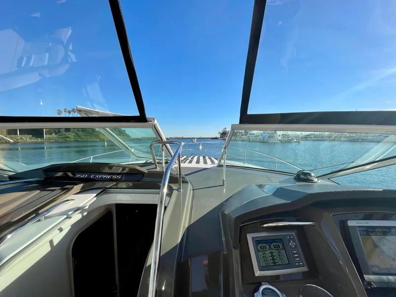 Slide: The Image of 2012 Cruisers Yachts 35 Express cockpit view with open water and clear sky. - 26