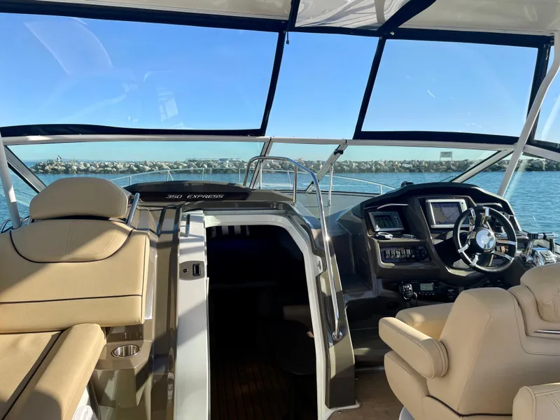 Slide: The Image of Interior view of 2012 Cruisers Yachts 35 Express, featuring helm and seating area. - 32