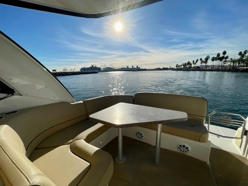 Slide: The Image of 2012 Cruisers Yachts 35 Express with sunlit seating area overlooking a serene harbor. - 34