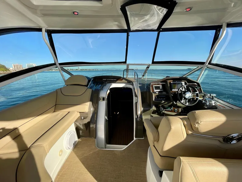 Slide: The Image of Interior of 2012 Cruisers Yachts 35 Express, featuring helm and seating, with ocean view. - 38