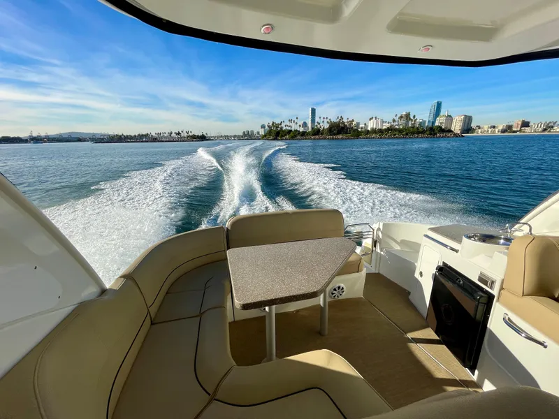 Slide: The Image of 2012 Cruisers Yachts 35 Express interior with ocean view and city skyline in background. - 39