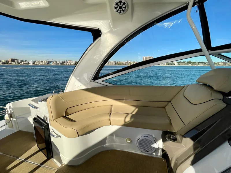 Slide: The Image of Luxurious 2012 Cruisers Yachts 35 Express interior with beige seating, overlooking serene waters. - 41