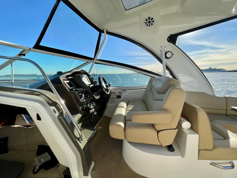 Slide: The Image of Interior of 2012 Cruisers Yachts 35 Express with helm and seating, overlooking the ocean. - 43