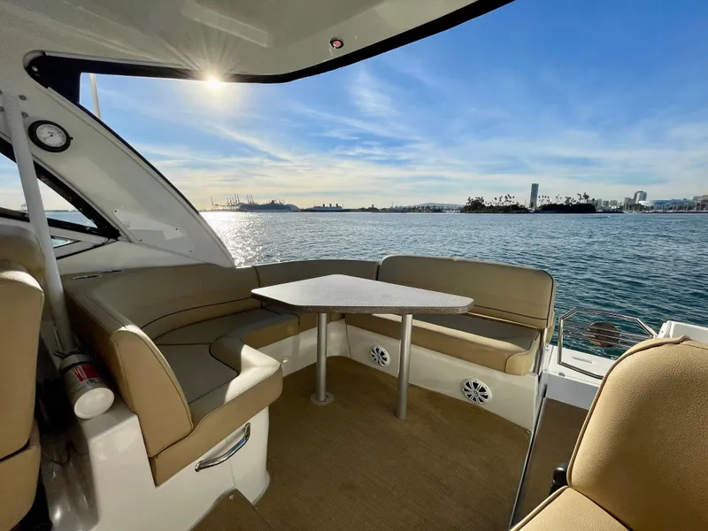 Slide: The Image of 2012 Cruisers Yachts 35 Express interior with seating, table, and scenic water view. - 44