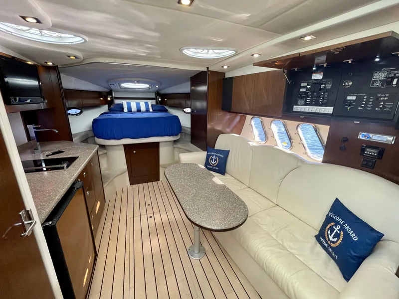 Slide: The Image of 2012 Cruisers Yachts 35 Express interior with modern kitchen, cozy seating, and elegant bedroom. - 9