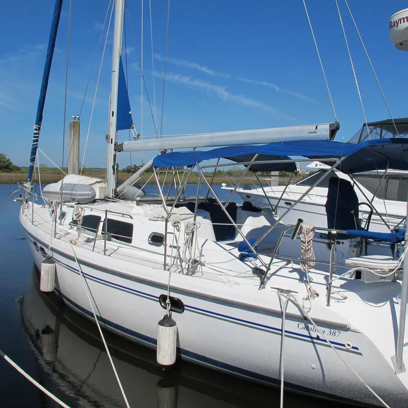 Slide: The Image of 2007 Catalina 387 sailboat docked on calm water under clear blue sky. - 0