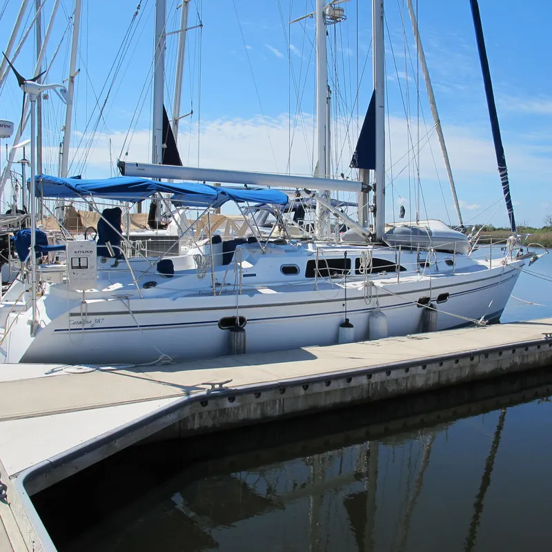 Slide: The Image of 2007 Catalina 387 sailboat docked at marina under clear blue sky. - 1