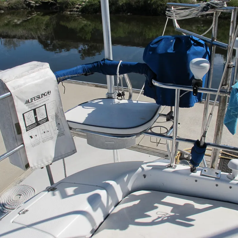 Slide: The Image of 2007 Catalina 387 sailboat deck with lifesaving equipment and blue covers. - 10