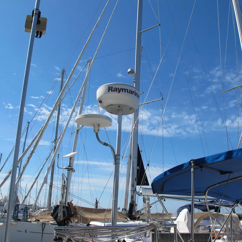 Slide: The Image of Sailboat masts and Raymarine equipment on a 2007 Catalina 387 under a clear blue sky. - 13