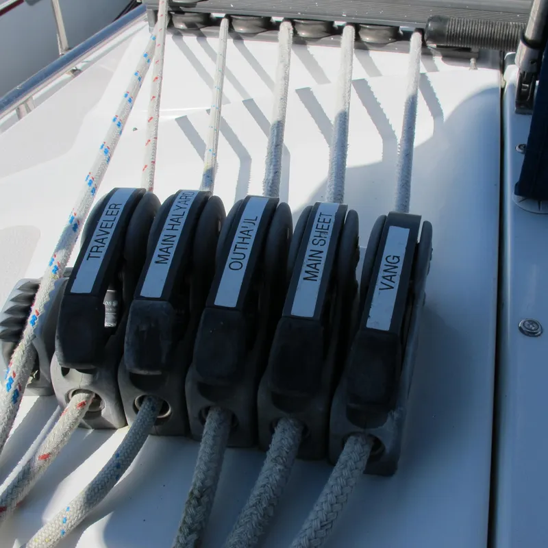 Slide: The Image of Sailboat rigging lines labeled: traveler, main halyard, outhaul, main sheet, vang, Catalina 387, 2007. - 19