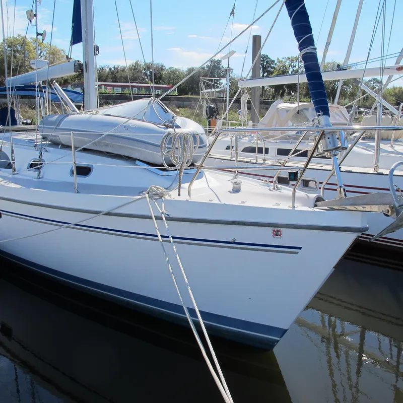 Slide: The Image of 2007 Catalina 387 sailboat docked in marina, featuring sleek design and white hull. - 2