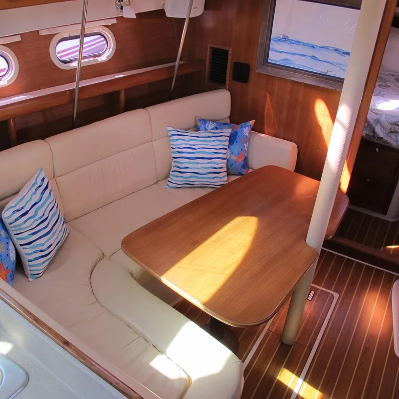 Slide: The Image of Interior of 2007 Catalina 387 sailboat with cozy seating and wooden table. - 24