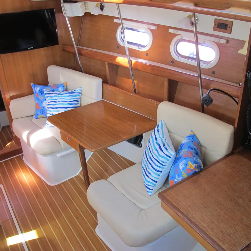 Slide: The Image of Interior of 2007 Catalina 387 yacht with cozy seating and nautical-themed pillows. - 27